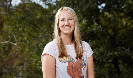 sara king smiling into camera with a squirrel shirt